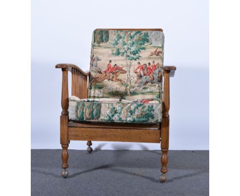 Oak framed reclining armchair, rectangular slatted back, plain arms with turned spindle sides, turned legs, labeled G and Com