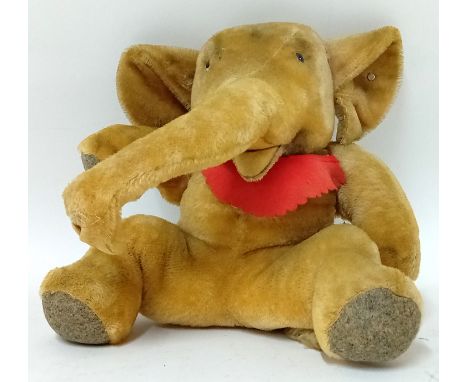 A Steiff baby elephant stuffed toy, with button to ear, stiff trunk, fluffy tail end, height approx 31cm.