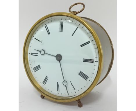 A brass drum clock, Roman enamel dial, resting on two feet, height 14cm.