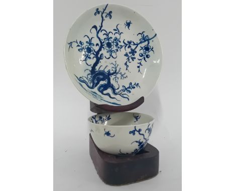 A tea bowl and saucer probably Dr Wall First period Worcester, glazed with blue floral decoration, saucer marked with a cresc