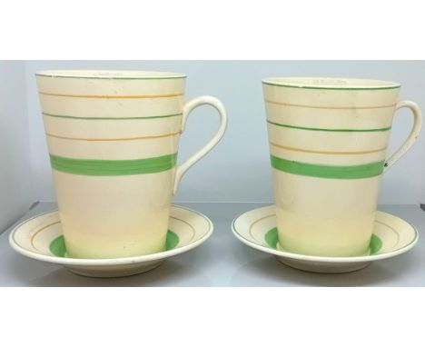 A pair of Clarice Cliff coffee cups and saucers, with striped green and orange on a pale yellow ground, stamped Clarice Cliff