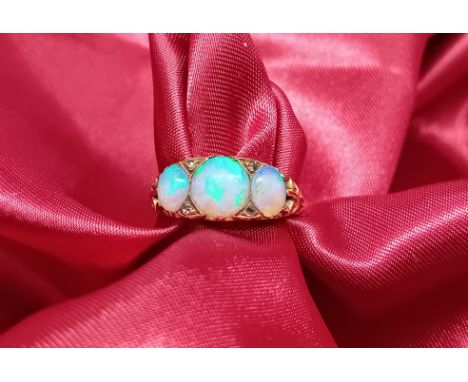 An 18ct yellow gold ring set with opal and diamond's, approx 3.1g, size K/L.