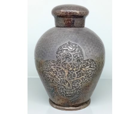 A Chinese silver tea caddy, with overall hammered design and tree of life decoration in a pointed quatrefoil motif with flowe