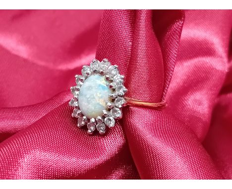 An 18ct yellow gold opal and diamond cluster set ring, approx 4.7g, size J.