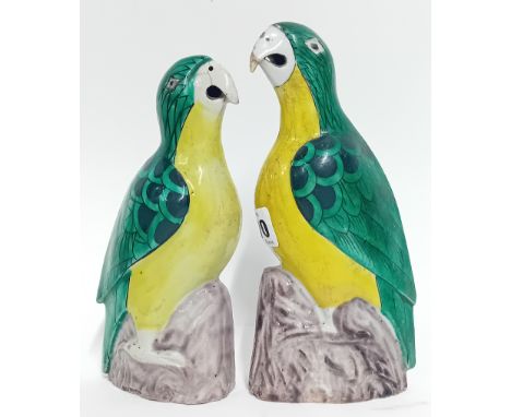 A 19th/20th century pair of Chinese ceramic parrots, green and yellow glazed, the large 20cm tall (2).