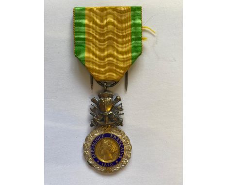 A French Medaille Militaire with yellow and green ribbon, crossed canons and armor suspension with silvered, gilt and enamel 