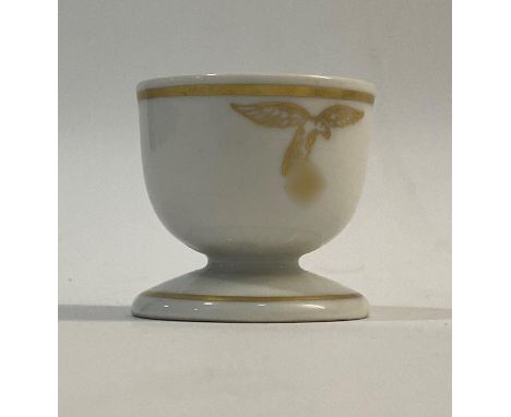 A ceramic eggcup with gold banding and Luftwaffe eagle and swastika, marked to the base 'Westerland 1939'  4.5c, high, 4.7cm 