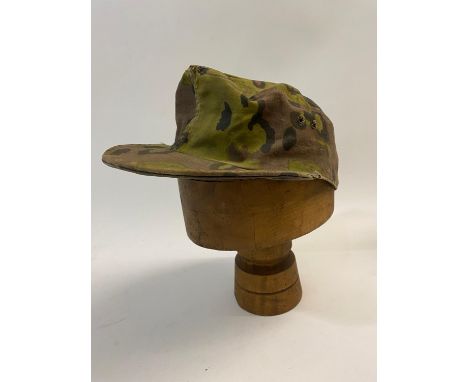 A German Waffen-SS camouflaged M43 style cap with two ventilation holes to either side.  *CR:  Slightly faded and with signs 