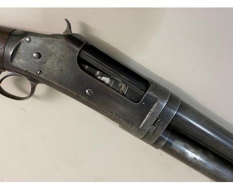 A Winchester 'Pump Action' 12 bore shotgun, engraved to the side plate 'Winchester Model 1897' and with various proof marks t