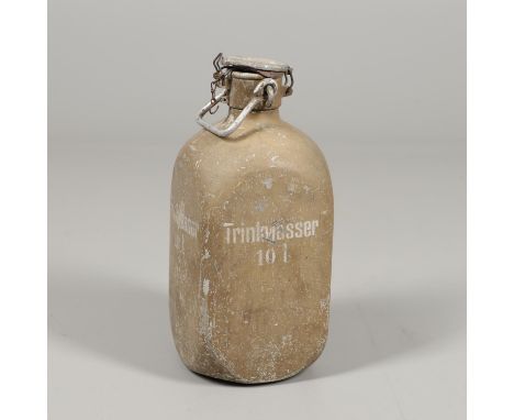 A square section aluminium flask with rounded corners finished in a pale sand colour, marked 'Trinkwasser 10l' (Drinkingwater