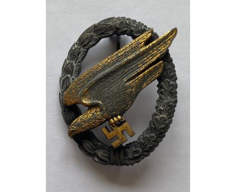 A Second World War German Luftwaffe Paratrooper's Badge, with a grey zinc wreath with gold plated eagle, the reverse with a t