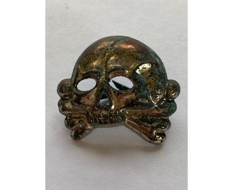 An early type Second World War German Allgemeine-SS early type cap skull stamped with RZM stamp and makers mark of 'ST. & L.L