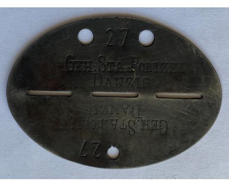 A Second World War Gestapo identity Disc, the zinc oval stamped '27  GEH.STA.POLIZEI  DANZIG'  for the Geheime Staatliche Pol