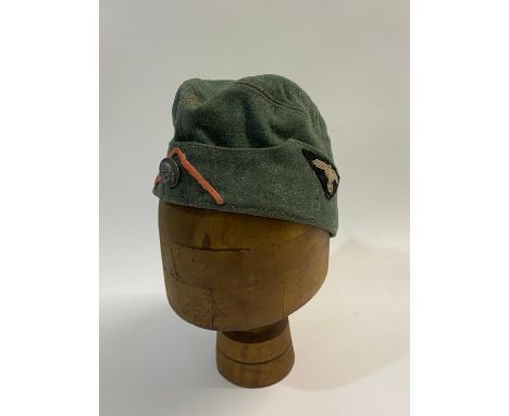 A Second World War German Waffen-SS Man's Forage Cap in fieldgrey material, with a triangular black felt badge with grey cott