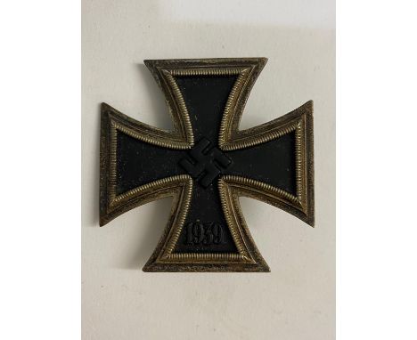 A Second World War or later German Iron Cross, First Class, the front with Swastika and date 1939, reverse with vertical pin.