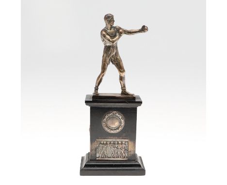 A boxing trophy with a silvered figure of a boxer in gloves on an ebonised plinth mounted with an 'Imperial Services Boxing A