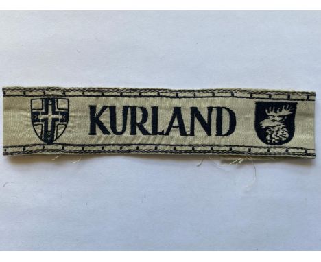A Second World War German Army 'Kurland' Cuffband, very pale grey or white cotton, the word 'Kurland' machine woven in black 