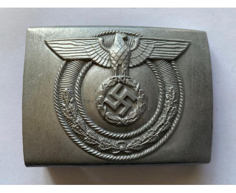 An unusual Second World War German Belt Buckle, with central swastika within a wreath and eagle above with geometric raised w