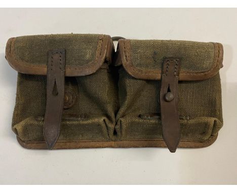 A Second World War German Ammunition pouch in canvas and leather for two rifle magazines, the brown leather straps on back st