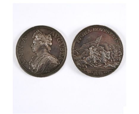 A silver medal, obverse bust left within Anna Augusta I.C. below the bust for J. Coker, reverse a heated cavalry engagement. 