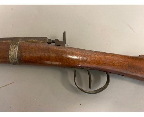 A primitive long-gun with a 121cm circular barrel with hammer action holding on half-cock and firing on full cock. With a ram