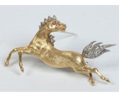 An 18 carat gold equestrian brooch. Formed as a galloping horse, set with a ruby and diamonds, D. Shackman & Sons. Assayed Lo