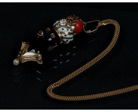 An 18 carat gold Blackamoor pendant on chain. Decorated in enamel, wearing seed pearl jewellery and a turban formed from a co