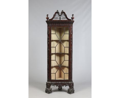 A nineteenth century Chippendale revival floor standing corner cupboard. With swan neck pediment, astrigal glazed, blind fret
