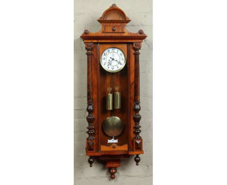 A nineteenth century walnut cased twin weight Vienna wall clock. With enamel dial having Arabic markers and subsidiary second
