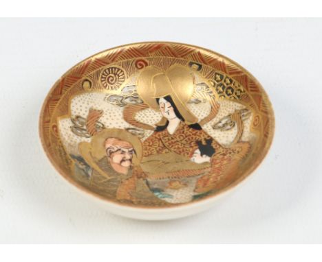 A Japanese Satsuma miniature dish. Decorated in enamel and gilt with deities, 6.5cm diameter. Condition Report. To be used as