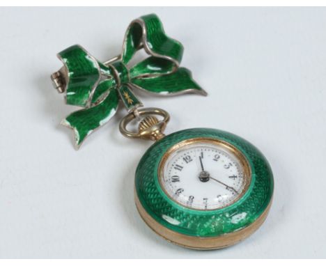 An early twentieth century Continental silver gilt ladies lapel watch supported on a ribbon shaped brooch and decorated with 