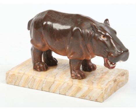 A Continental porcelain model of a hippopotamus raised on a mammoth tooth plinth with moulded edge, 9cm. Condition Report. To