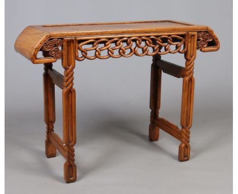 A Chinese late Qing dynsaty pale hardwood alter table. With scrolling top and a carved open work ruyi branch frieze raised on