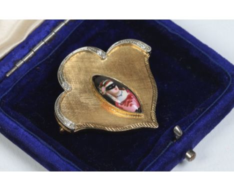 An Italian 1960s 18 carat gold fan shaped brooch set with diamonds and with a textured ground supporting a navette shaped por