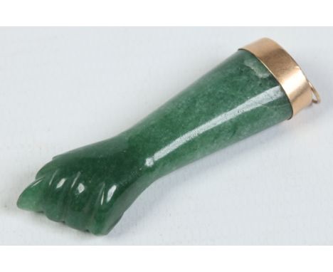 A carved jade pendant formed as a stylized clenched fist and with yellow metal mount, 5.5cm. Condition Report. To be used as 