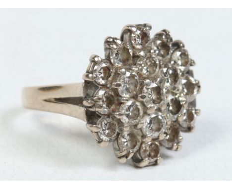 An 18 carat gold diamond three tier cluster ring. Set with 19 brilliant cut diamonds approximately 2.2ct, ring size K.  Condi