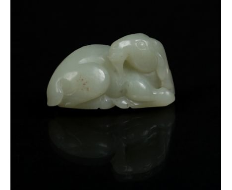 A nineteenth century Chinese carved celadon jade model of a recumbent goat, 5.75cm. Condition Report. To be used as a guide o