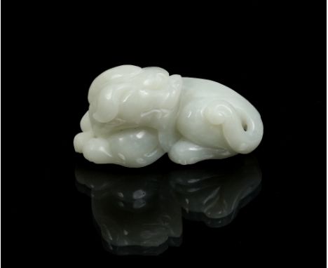 A Chinese nineteenth century celadon jade carving of a Pixiu, recumbent and with its head turned over its shoulder, 8cm. Cond