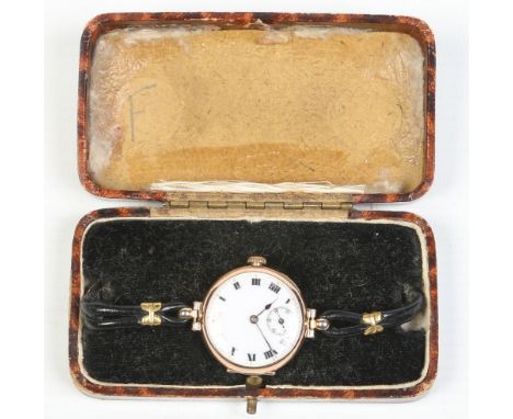 An antique ladies Rolex manual wristwatch in 9 carat gold case and with leather strap. With enamel dial having Roman numeral 