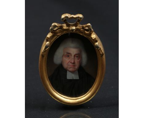 A nineteenth century enamel portrait miniature in gilt gesso frame. Portrait of an eldery clergyman in robes, 5.5cm x 4.25cm.