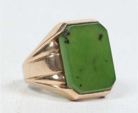 A gentleman's 9 carat gold signet ring set with a canted rectangular jade tablet. Size U, 10.2 grams.  Condition Report. To b