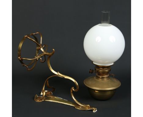 An Art Nouveau oil lamp on lacquered brass wall sconce and having white opaque glass shade, 78cm. Condition Report. To be use