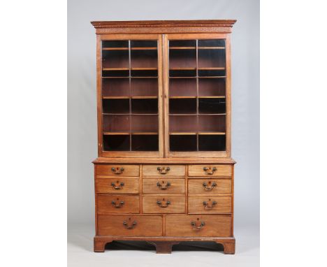 A George III mahogany library bookcase. With doric moulding and blind fret carving to the cornice, with two astrigal glazed c
