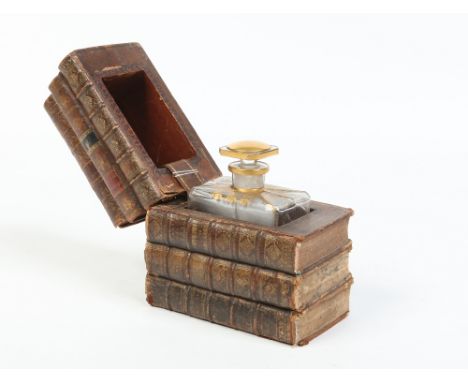 A Courvoisier glass decanter with gilt decoration and in novelty fitted box, leather bound and formed as a pile of six books,