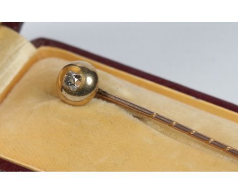A cased yellow metal stick pin set with a solitaire brilliant cut diamond.  Condition Report. To be used as a guide only. Goo