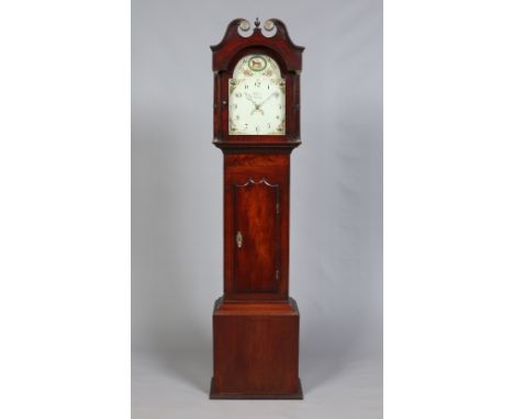 A George IV mahogany longcase clock by W. Raw, Whitby. Housing a thirty hour movement, with painted arch top dial having Arab