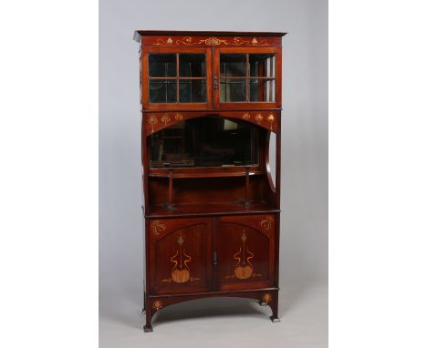 An Art Nouveau Liberty style marquetry inlaid mahogany side cabinet of tall and slender proportions. With cushion glass to th