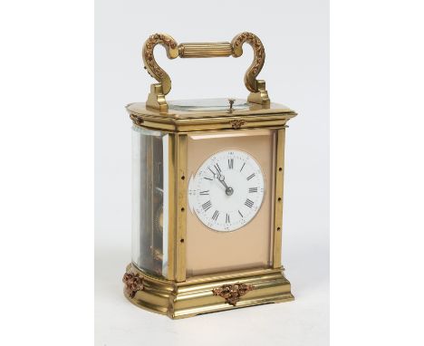 A late nineteenth century French brass cased carriage clock with bowed glass sides. Housing a two train movement with platfor