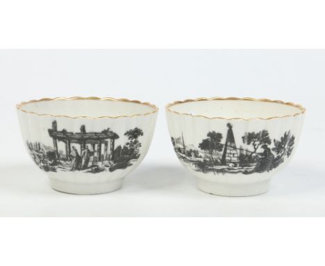 A pair of Worcester fluted teabowls with gilt rims. Printed in black with landscape vignettes incorporating ruins and follys 