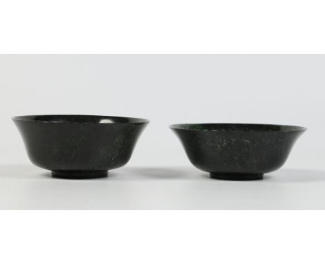 A pair of Chinese turned spinach jade bowls with everted rims, 15cm diameter. Condition Report. To be used as a guide only. G